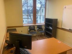 Study room with table, chairs, computer, whiteboard, and shelf